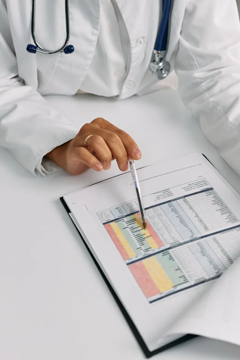Doctor reviewing NHS pension and tax documents with accountant in Slough