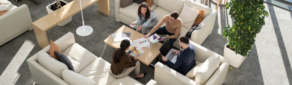 Group of young auditors of high tech corporation discussing documents