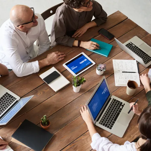 Team of accountants working on laptops and financial documents in Slough office